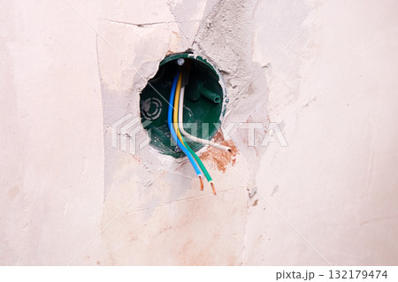 Electrical box for wires is built into the wall, and during home renovation, wires stick out. 132179474