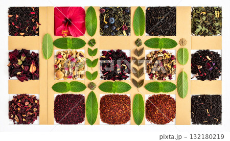 Flat lay of assorted herbal tea ingredients like hibiscus, rooibos, peppermint, and dried botanicals arranged in geometric harmony, symbolizing natural wellness, balance, and holistic healing 132180219
