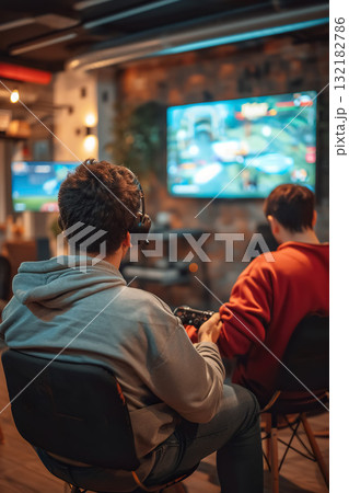happy couple playing video game with controller on play station at home, friends play computer games on console and have fun 132182786