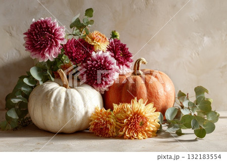Autumn arrangement with pumpkins and vibrant flowers showcasing seasonal harvest beauty 132183554