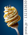 Macro studio image of fork holding twirled spaghetti with olive oil and spices 132183630