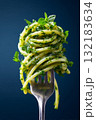 Hyperrealistic close-up of fork with spaghetti and fresh herbs on a dark background 132183634