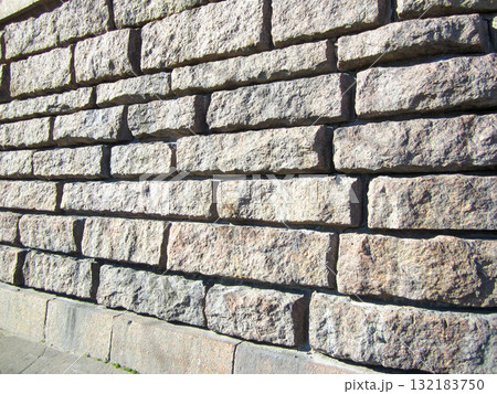 Full frame textured stone wall in sunlight. 132183750