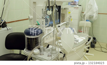 Anesthesia machine positioned within pristine operating room environment, monitoring surgical anesthetic delivery with advanced technological precision and patient safety controls Anesthesia machine positioned within pristine operating room environment, monitoring surgical anesthetic delivery with advanced technological precision and patient safety controls 132184023