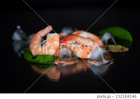 Appetizing shrimp with spices on a black background studio Appetizing shrimp with spices on a black background studio 132184146