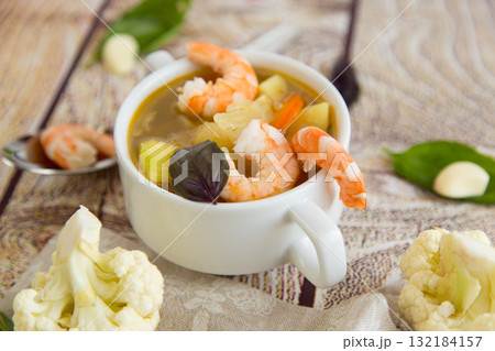 Culinary Serving of Hot Shrimp Soup on a Wooden Table Culinary Serving of Hot Shrimp Soup on a Wooden Table 132184157