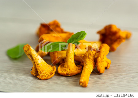 bowl with wild chanterelle mushrooms on a wooden table bowl with wild chanterelle mushrooms on a wooden table 132184166