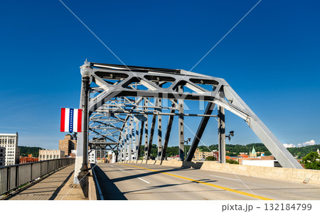 The South Side Bridge, a cantilever truss structure, crossing the Kanawha River in Charleston, West Virginia, USA. A flag of the city is on display 132184799
