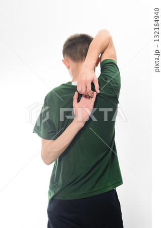 Man stretching his back and shoulders, viewed from behind. Simple exercise for flexibility and posture. 132184940