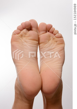 Close-up of clean soles of feet against a white background. Perfect for health, wellness, or hygiene related projects. 132184989