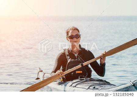 Kayaking, Water, Paddle - Woman in Sunglasses Kayaking on a Calm Water Body on a Sunny Day Kayaking, Water, Paddle - Woman in Sunglasses Kayaking on a Calm Water Body on a Sunny Day 132185040