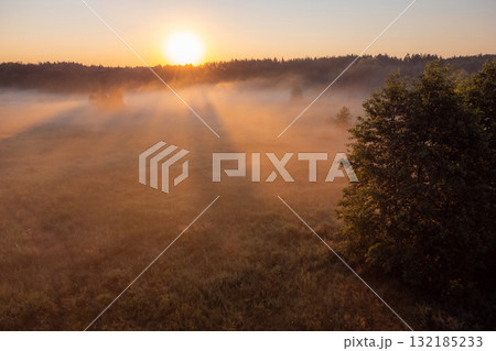 Sun illuminate morning mist in the valley. Early in the morning in summer season Sun illuminate morning mist in the valley. Early in the morning in summer season 132185233