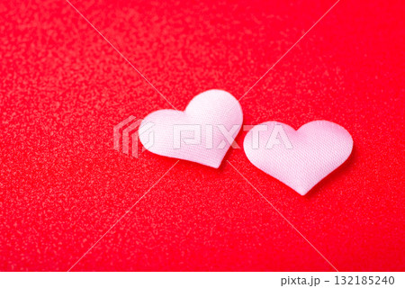 Minimalistic background of two pink hearts on red background. Valentine`s day concept 132185240