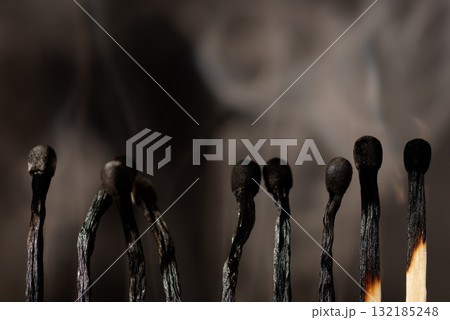 Line of just burnt matches with some smoke in the background. Concept of ending, finish. 132185248
