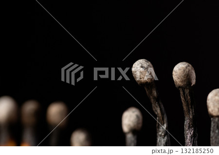 Close-up shot of burnt matches. Macro photo of black burnt match heads 132185250