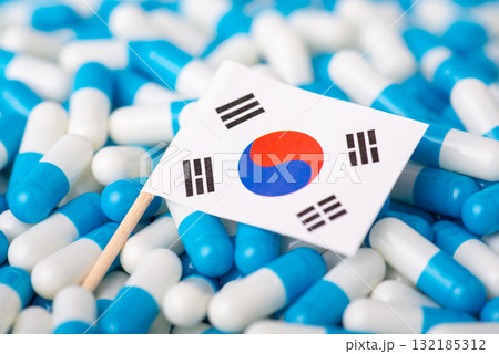 Epidemic in Korea. Flag of South Korea on piles of pills Epidemic in Korea. Flag of South Korea on piles of pills 132185312
