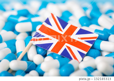 Pandemic in UK. Union Jack on pile of medical pills capsules 132185313
