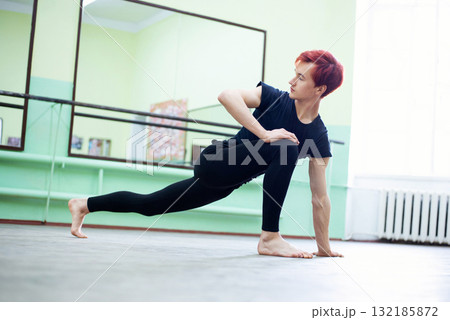 Stretching before intensive lesson of dancing. Young male dancer preparing for the lesson in dancing school, warming up Stretching before intensive lesson of dancing. Young male dancer preparing for the lesson in dancing school, warming up 132185872