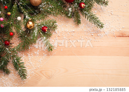 Christmas tree branches on yellow wooden table sesoned with light snow. Christmas copy space Christmas tree branches on yellow wooden table sesoned with light snow. Christmas copy space 132185885