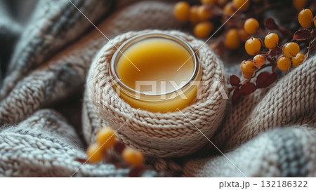 Lip balm on blanket, juxtaposed pocket background Winter lipstick with oil Lip balm on blanket, juxtaposed pocket background Winter lipstick with oil 132186322