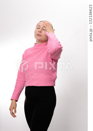 Woman experiencing discomfort, holding her head with her hand. 132186625