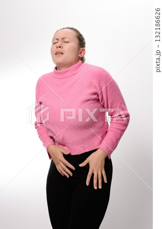 Woman experiencing abdominal discomfort or pain. Woman experiencing abdominal discomfort or pain. 132186626