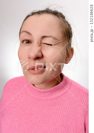 Woman winking and making a face Woman winking and making a face 132186628
