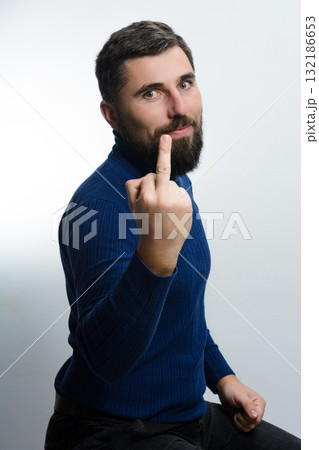 Man making rude gesture. Conveying anger or disrespect. 132186653
