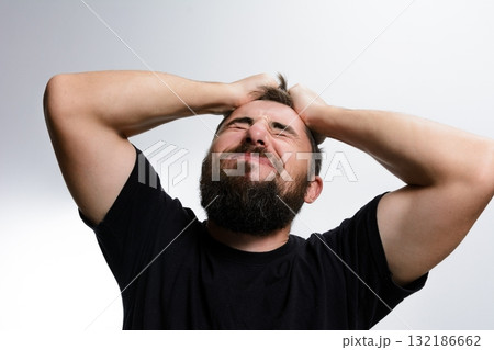 Man with beard experiencing frustration and stress. 132186662
