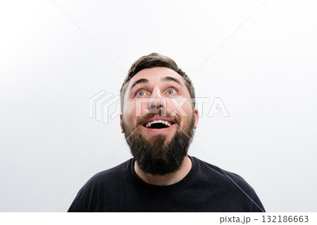 Bearded man looking up with amazement Bearded man looking up with amazement 132186663