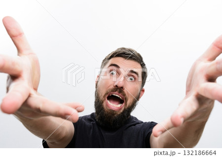 Man with beard reaching forward with open hands and surprised expression. Man with beard reaching forward with open hands and surprised expression. 132186664