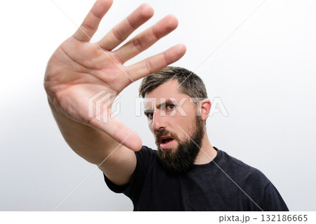 Man with beard raising hand in stop gesture Man with beard raising hand in stop gesture 132186665