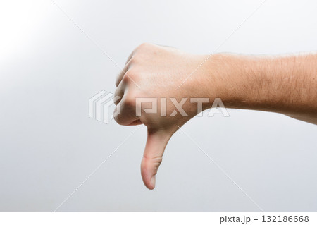Hand giving thumbs down gesture. Hand giving thumbs down gesture. 132186668