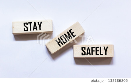 Wooden blocks with the text STAY AT HOME. BE SAFE. 132186806
