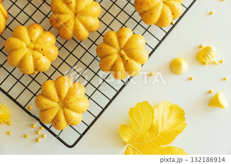 Autumn-Themed Mini pumpkin Cakes with Seasonal Decorations on White Background Autumn-Themed Mini pumpkin Cakes with Seasonal Decorations on White Background 132186914