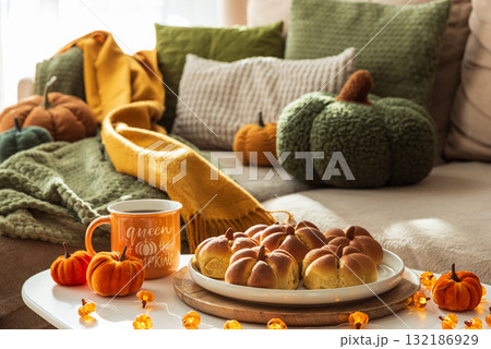 Autumn Table Setting with Pumpkin-Shaped buns with Cinnamon, Apples, Pumpkins, and Cozy Decor Autumn Table Setting with Pumpkin-Shaped buns with Cinnamon, Apples, Pumpkins, and Cozy Decor 132186929