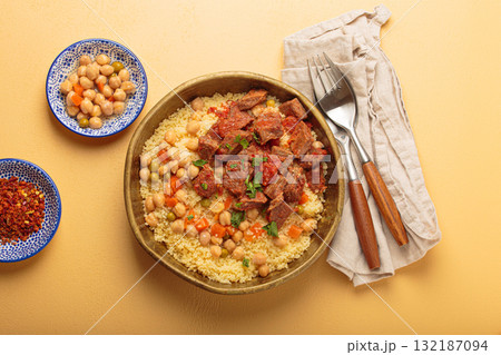 Moroccan couscous with tender meat and chickpea stew in rustic bow top view, Maghreb cuisine 132187094