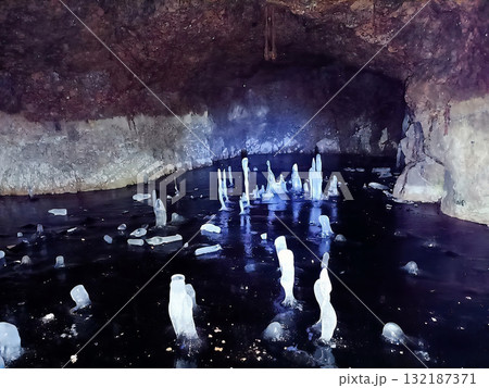 A cave with a stream of water and ice in it A cave with a stream of water and ice in it 132187371