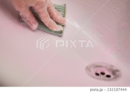 Cleaning a sink requires careful attention and effort to maintain hygiene and a fresh appearance 132187444