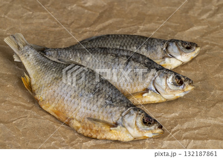 dry fish for long-term storage by dehydrating whole fish in the sun, semi-finished product of dehydrated and dried fish in scales ready for human consumption 132187861