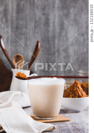 Asian miso sweet salty coffee in a glass on the table vertical view Asian miso sweet salty coffee in a glass on the table vertical view 132188010