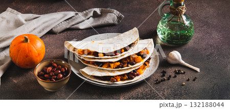 Vegetarian tacos with red beans and pumpkin on a plate on the table web banner 132188044