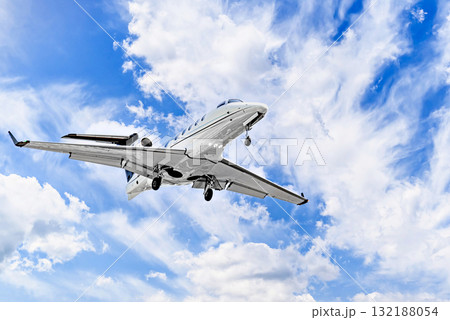 Private business plane flying under blue sky with white clouds 132188054