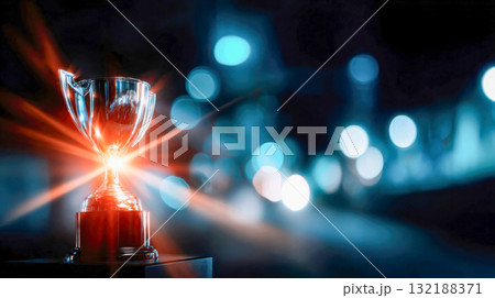 Golden trophy shining brightly against a colorful bokeh night background Golden trophy shining brightly against a colorful bokeh night background 132188371