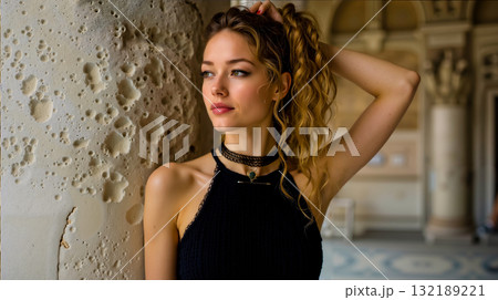 A woman leaning against a wall with her hair in a ponytail A woman leaning against a wall with her hair in a ponytail 132189221