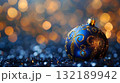 A blue and gold ball with copy place. Christmas background creating a festive and cozy atmosphere 132189942