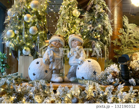 A festive and cosy indoor scene featuring a Christmas or Winter holiday display, likely within a hotel lobby 132190312