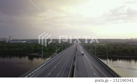 Aerial view of highway bridge traffic over a river at sunset. Clip 132190341