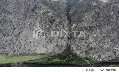 Waterfall cascading into valley between mountains in altai republic. Media Waterfall cascading into valley between mountains in altai republic. Media 132190496