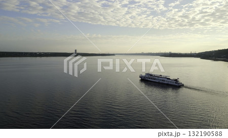 Passenger ferry boat cruising on a river under a cloudy sky. Clip 132190588